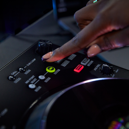 Close-up of the Pioneer DDJ-FLX10 track browsing controls beside the jog wheel, with a DJ operating the deck.